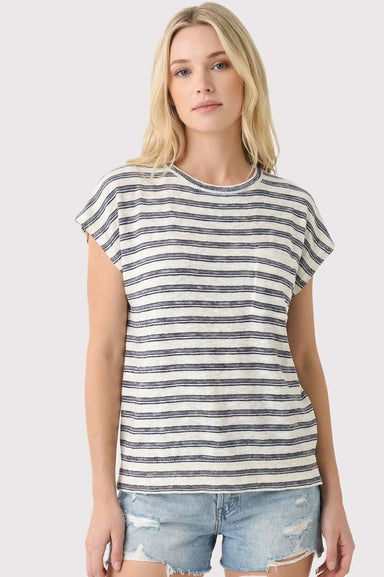 Woman wearing a striped t-shirt and denim shorts on a plain background