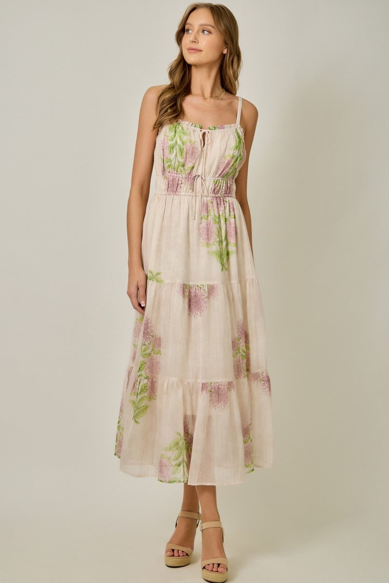 Woman wearing a floral dress against a plain background